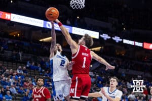 Creighton Bluejay guard Pop Isaacs (2) makes a layup against Nebraska Cornhusker guard Sam Hoiberg (1) in the second half during a college basketball game Friday, November 22, 2024 in Omaha, Nebraska. Photo by John S. Peterson.