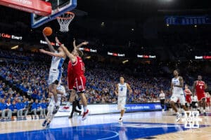 Creighton Bluejay guard Pop Isaacs (2) makes a layup against Nebraska Cornhusker guard Sam Hoiberg (1) in the second half during a college basketball game Friday, November 22, 2024 in Omaha, Nebraska. Photo by John S. Peterson.