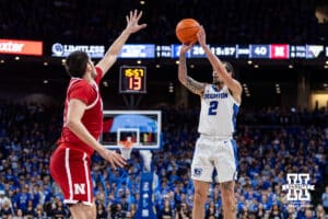 Creighton Bluejay guard Pop Isaacs (2) makes a three point shot against Nebraska Cornhusker forward Berke Buyuktuncel (9) in the second half during a college basketball game Friday, November 22, 2024 in Omaha, Nebraska. Photo by John S. Peterson.