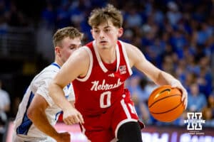 Nebraska Cornhusker guard Connor Essegian (0) dribbles the ball against Creighton Bluejay guard Steven Ashworth (1) in the first half during a college basketball game Friday, November 22, 2024 in Omaha, Nebraska. Photo by John S. Peterson.