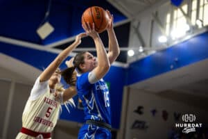 Creighton Bluejay guard Lauren Jensen (15) makes a layup agianst Nebraska Cornhusker guard Alberte Rimdal (5) in the first half during a women’s college basketball game Friday, November 22, 2024 in Omaha, Nebraska. Photo by John S. Peterson.