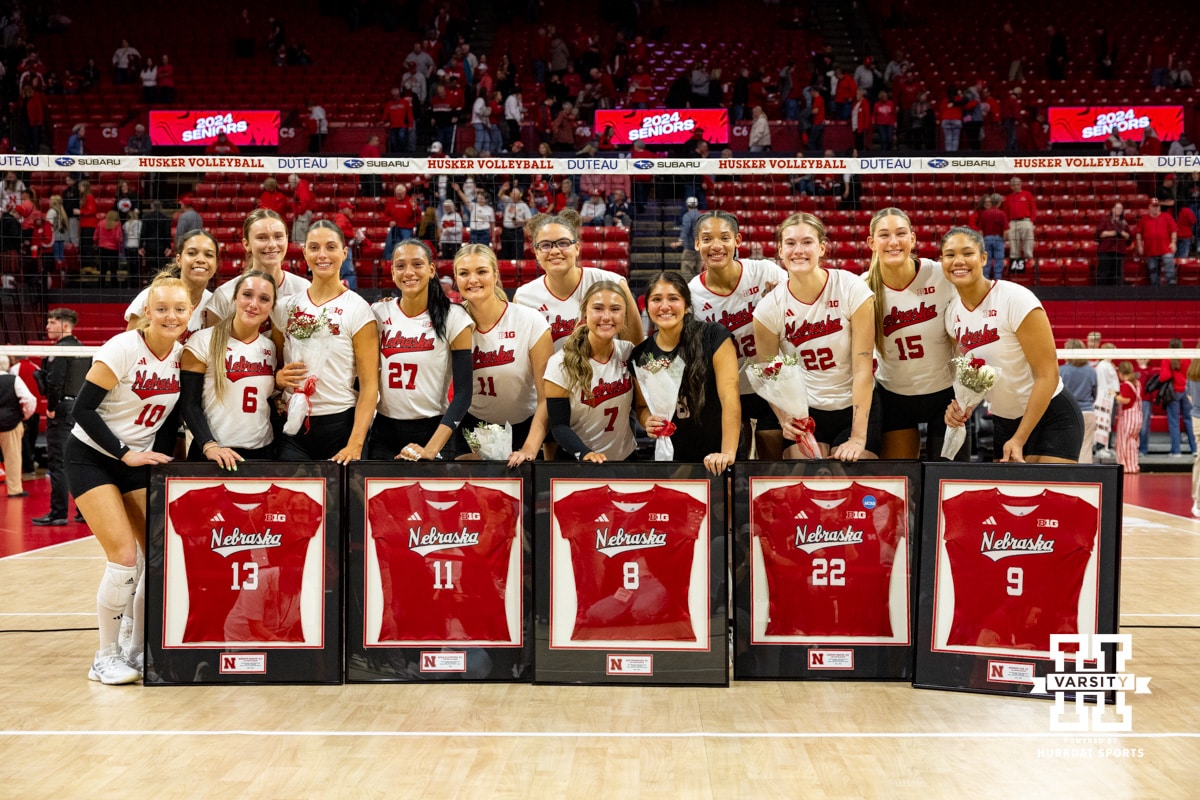 Nebraska Volleyball v Wisconsin November 23, 2024. Seniors Merritt Beason (13), Leyla Blackwell (11), Lexi Rodriguez (8), Lindsay Krause (22), and Kennedi Orr (9) pose for a photo with teammates after beating Wisconsin on Senior night. Photo by John S. Peterson.