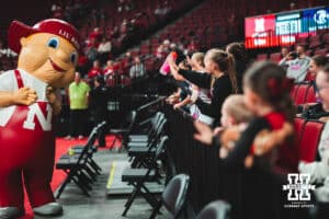 Kid fans wave to Lil' Red before a college basketball game Tuesday, November 19, 2024, in Lincoln, Nebraska. Photo by Charlotte A. Gottfried.
