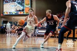 Nebraska Cornhusker guard Connor Essegian (0) drives the lane against St. Mary's Gaels forward Luke Barrett (33) during a college basketball game Sunday, November 17, 2024 in Sioux Falls, South Dakota.