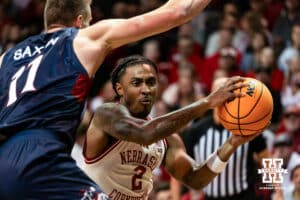 Nebraska Cornhusker guard Ahron Ulis (2) makes a pass against St. Mary's Gaels center Mitchell Saxen (11) during a college basketball game Sunday, November 17, 2024 in Sioux Falls, South Dakota.
