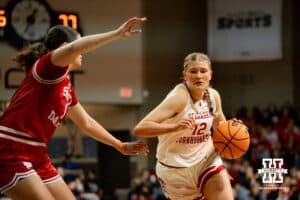 Nebraska Cornhusker forward Jessica Petrie (12) dribbles the ball against South Dakota Coyote forward Gabby Wilke (1) during a college women's basketball game Saturday, November 16, 2024 in Sioux Falls, South Dakota. Photo by Collin Stilen.
