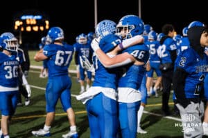 Aidan Smith and Cole Miller embrace after a 4th down stop during a high school football game November 15th, 2024 in Bennington Nebraska Photo by Brandon Tiedemann