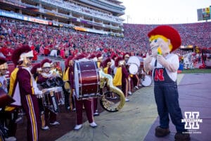 Nebraska Cornhusker mascot Herbie explains the benefits of corn the the USC Trojans matching band during a college football game Saturday, November 16, 2024 in Los Angeles, California. Photo by John S. Peterson.