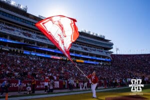 Nebraska Cornhuskers cheer squad member waves the Nebraska flag in the endzone after a touchdown in the second quarter against the USC Trojans during a college football game Saturday, November 16, 2024 in Los Angeles, California. Photo by John S. Peterson.