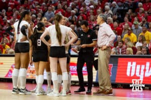 Nebraska Cornhuskers huddle up at a challenge with call during a college volleyball match against the Minnesota Golden Gophers Thursday, November 14, 2024, in Lincoln, Nebraska. Photo by John S. Peterson.