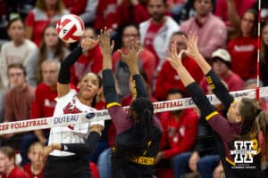 Nebraska Cornhusker Taylor Landfair (12) spikes the ball against Minnesota Golden Gopher Phoebe Awoleye (7) and Melani Shaffmaster (5) in the fourth set during a college volleyball match Thursday, November 14, 2024, in Lincoln, Nebraska. Photo by John S. Peterson.