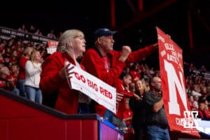 Nebraska Cornhuskers holding up their signs at a break in the action against the Minnesota Golden Gophers in the fourth set during a college volleyball match Thursday, November 14, 2024, in Lincoln, Nebraska. Photo by John S. Peterson.