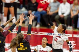 Nebraska Cornhusker Taylor Landfair (12) tipe tips the ball over the net against the Minnesota Golden Gophers in the second set during a college volleyball match Thursday, November 14, 2024, in Lincoln, Nebraska. Photo by John S. Peterson.