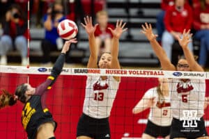 Nebraska Cornhusker Merritt Beason (13) and Nebraska Cornhusker Rebekah Allick (5) jump. up to block Minnesota Golden Gopher Julia Hanson (22) in the third set during a college volleyball match Thursday, November 14, 2024, in Lincoln, Nebraska. Photo by John S. Peterson.