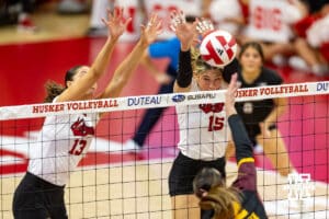Nebraska Cornhusker Andi Jackson (15) and Merritt Beason (13) jump to block Minnesota Golden Gopher Julia Hanson (22) in the second set during a college volleyball match Thursday, November 14, 2024, in Lincoln, Nebraska. Photo by John S. Peterson.