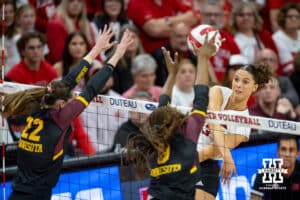 Nebraska Cornhusker Merritt Beason (13) spikes the ball against Minnesota Golden Gopher Julia Hanson (22) and Calissa Minatee (8) in the second set during a college volleyball match Thursday, November 14, 2024, in Lincoln, Nebraska. Photo by John S. Peterson.