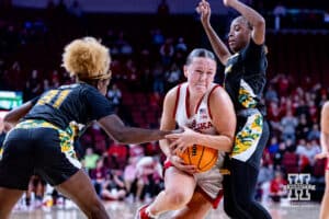 Nebraska Cornhusker guard Callin Hake (14) drives to the lane against SE Louisiana Lady Lion guard Alexius Horne (31) and guard Jalencia Pierre (1) in during a women’s college baskteball game Saturday, November 9, 2024, in Lincoln, Nebraska. Photo by John S. Peterson.
