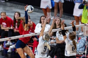 Norris's Malorie Boesiger (7) spikes the ball against Elkhorn North's Reagan Wallraff (9) and Hayden Booth (6) during the semi-finals of the 2024 NSAA Volleyball Championships Friday, November 8, 2024, in Lincoln, Nebraska. Photo by John S. Peterson.