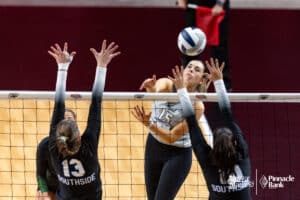 Millard West's Halle Kerkman (15) spikes the ball against Papillion-La Vista South's Madeline Larsen (13) and Charlette Solomon (10) during the semi-finals of the 2024 NSAA Volleyball Championships Friday, November 8, 2024, in Lincoln, Nebraska. Photo by John S. Peterson.