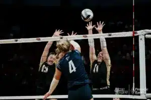 Freeman's Rilyn Otto (4) spikes the ball against Thayer Central's Libby Hergott (13) and Ella Brueggemann (11) during the NSAA State Volleyball Quarterfinals on November 6th, 2024 at Pinnacle Bank Arena in Lincoln, Nebraska. Photo by Mike Sautter.