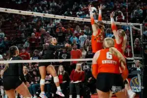 Johnson-Brock's Daley Pelican (2) spikes the ball against Oakland-Craig's Mia Thomsen (3) and Brinley Eriksen (1) during the NSAA State Volleyball Quarterfinals on November 6th, 2024 at Pinnacle Bank Arena in Lincoln, Nebraska. Photo by Mike Sautter.
