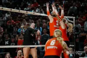 Johnson-Brock's Taryn Ottemann (12) spikes the ball against Oakland-Craig's Mia Thomsen (3) and Brinley Eriksen (1) during the NSAA State Volleyball Quarterfinals on November 6th, 2024 at Pinnacle Bank Arena in Lincoln, Nebraska. Photo by Mike Sautter.