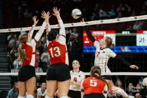 Superior's Halle Bargen (7) spikes the ball past Cedar Catholic's Addison Walter and Melayna McGregor (12) during the NSAA State Volleyball Quarterfinals on November 6th, 2024 at Pinnacle Bank Arena in Lincoln, Nebraska. Photo by Mike Sautter.