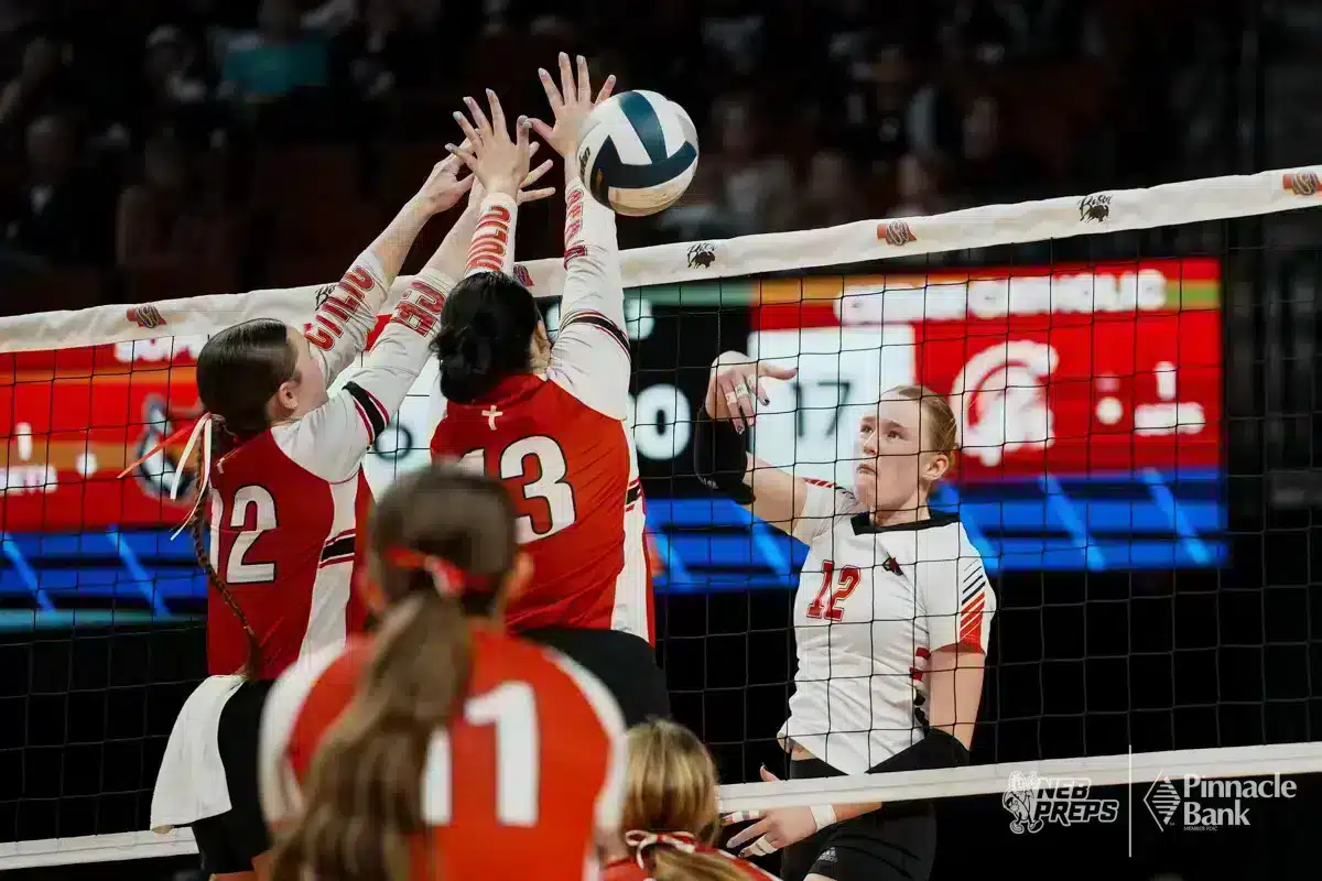 Superior's Reagan Meyers (12) spikes the ball past Cedar Catholic's Addison Walter and Melayna McGregor (12) during the NSAA State Volleyball Quarterfinals on November 6th, 2024 at Pinnacle Bank Arena in Lincoln, Nebraska. Photo by Mike Sautter.