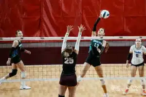 Shelton's Erin Gegg (13) spikes the ball against Stuart's Addison Steinhauser (25) during the NSAA State Volleyball Quarterfinals on November 6th, 2024 at Pinnacle Bank Arena in Lincoln, Nebraska. Photo by Mike Sautter.