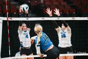 Wynot's Jordan Foxhoven (14) spikes the ball against Overton's Kyla Elfgren (4) and Gracen Hughes during the NSAA State Volleyball Quarterfinals on November 6th, 2024 at Pinnacle Bank Arena in Lincoln, Nebraska. Photo by Mike Sautter.