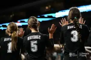 Waverly's Mia Manning, Tyka Hoos, and Gracie Lauenstein giving high fives against Bennington during the NSAA State Volleyball Quarterfinals on November 6th, 2024 at Pinnacle Bank Arena in Lincoln, Nebraska. Photo by Mike Sautter.