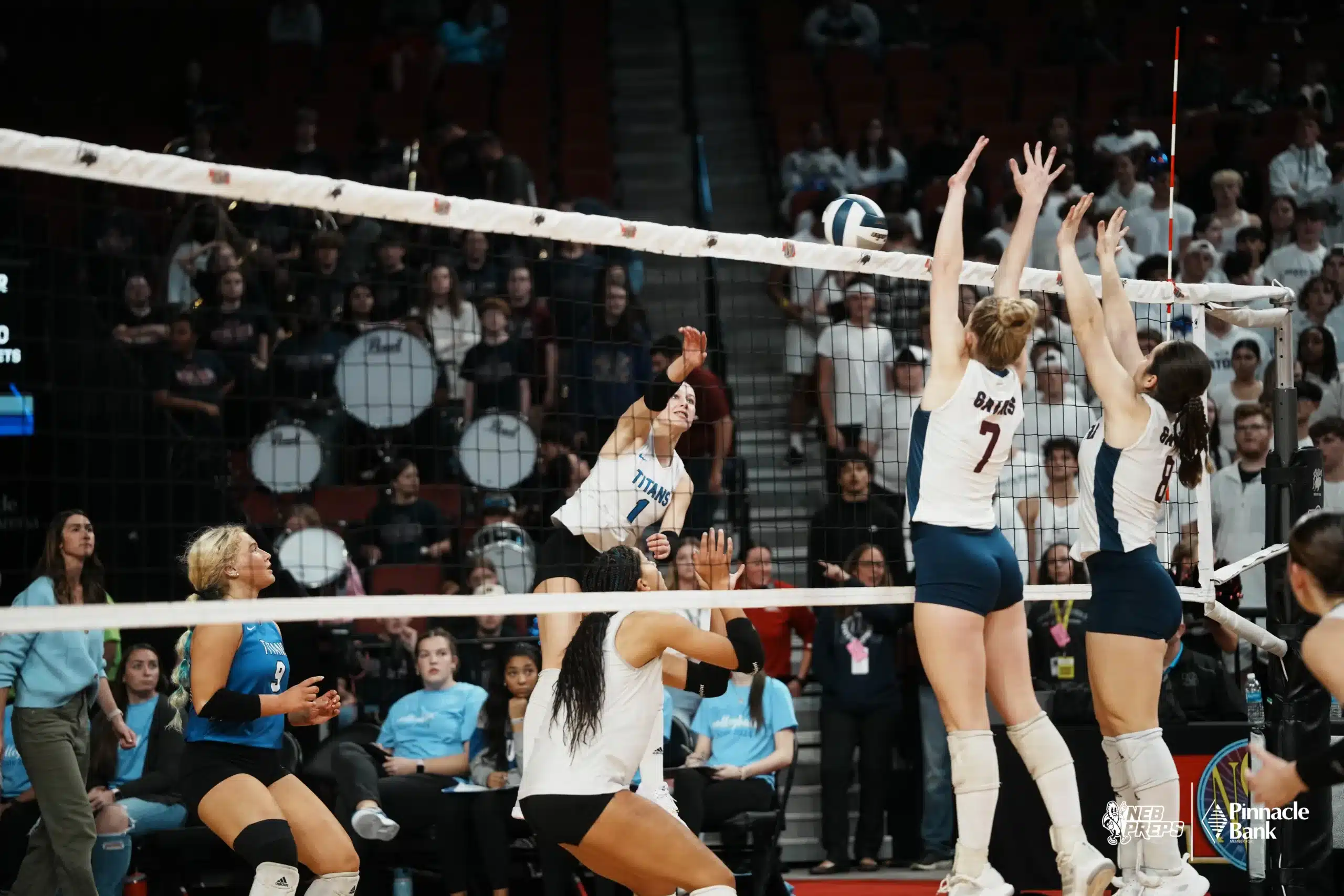 Papillion-LaVista South Titan Finley Moone (1) spikes the ball against North Star Gators Lauren McKeman (7) and Alexandra Kroll (8) during NSAA State Volleyball quarterfinals at Pinnacle Bank Arena on November 6th, 2024. Photo by Mike Sautter