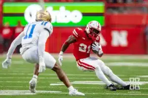 Nebraska Cornhusker running back Emmett Johnson (21) runs with the ball in the fourth quarter against UCLA Bruin defensive back Ramon Henderson (11) during a college football game Saturday, November 2, 2024, in Lincoln, Nebraska. Photo by John S. Peterson.