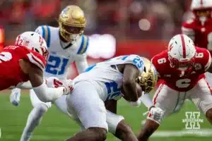 Nebraska Cornhusker linebacker Mikai Gbayor (42) and Nebraska Cornhusker defensive back Tommi Hill (6) tackle UCLA Bruin running back T.J. Harden (25) in the fourth quarter during a college football game Saturday, November 2, 2024, in Lincoln, Nebraska. Photo by John S. Peterson.