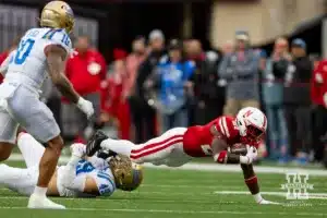 Nebraska Cornhusker running back Emmett Johnson (21) dives for a few extra yards against UCLA Bruin linebacker JonJon Vaughns (21) in the third quarter during a college football game Saturday, November 2, 2024, in Lincoln, Nebraska. Photo by John S. Peterson.