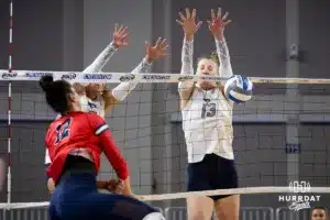 Creighton Bluejay defensive specialist Morgan Colangelo (13) blocks a shot from St. John's Red Storm outside hitter Giorgia Walther (12) in the third set during a college volleyball match Friday, November 1, 2024, in Omaha, Nebraska. Photo by John S. Peterson.