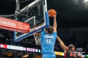 Creighton Bluejays Ryan Kalkbrenner grabs the lob pass against St John's Red Storm during a college basketball game Tuesday, December 31, 2024, in Omaha, Nebraska. Photo by Brandon Tiedemann.