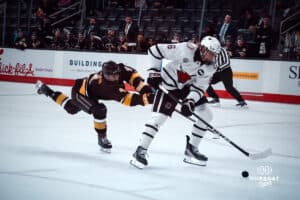 UNO Mavericks player, Zach Urdahl, speeds past a Manitoba player during a college hockey game on Dec 29, 2024 in Omaha, Nebraska. Photo by Logan Hock