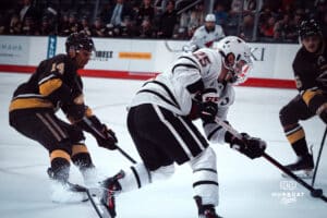UNO Mavericks player, Cameron Mitchell, speeds past Manitoba players during a college hockey game on Dec 29, 2024 in Omaha, Nebraska. Photo by Logan Hock