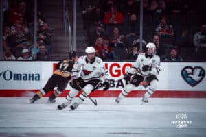 UNO Mavericks players, Liam Watkins and Noah Ellis, playing defense during a college hockey game on Dec 29, 2024 in Omaha, Nebraska. Photo by Logan Hock