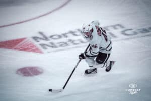 UNO Mavericks player, Dylan Gratton, handles a puck during a college hockey game on Dec 29, 2024 in Omaha, Nebraska. Photo by Logan Hock