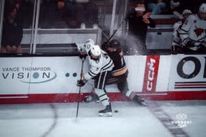 UNO Mavericks player, Joe Gramer, clashes with a Manitoba player during a college hockey game on Dec 29, 2024 in Omaha, Nebraska. Photo by Logan Hock