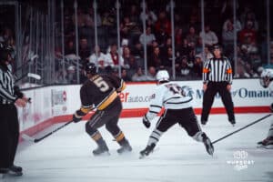 UNO Mavericks player, Myles Hilman, chases down a puck during a college hockey game on Dec 29, 2024 in Omaha, Nebraska. Photo by Logan Hock