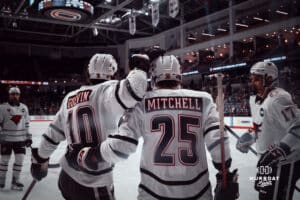 UNO Mavericks Cameron Mitchell and Jacob Guevin celebrate a goal during a college hockey game on December 29, 2024 in Omaha, Nebraska. Photo by Logan Hock.