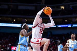 Nebraska Cornhuskers guard Gavin Griffiths (12) makes a layup against Southern University Jaguars forward AJ Barnes (12) in the second half during college basketball game, Monday, December 30, 2024, in Lincoln, Nebraska. Photo by John S. Peterson.