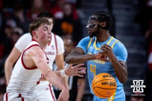 Nebraska Cornhuskers guard Connor Essegian (0) bats the ball away from Southern University Jaguars forward Derrick Tezeno (4) in the first half during college basketball game, Monday, December 30, 2024, in Lincoln, Nebraska. Photo by John S. Peterson.