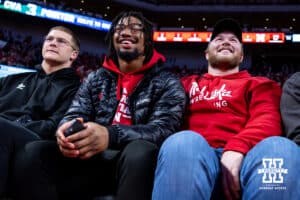 Nebraska Cornhusker footbal players Ty Robinson, MJ Sherman, and Nash Hutmacker watching the game against the Southern University Jaguars during college basketball game, Monday, December 30, 2024, in Lincoln, Nebraska. Photo by John S. Peterson.