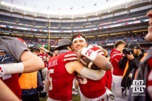 Nebraska Cornhuskers quarterback Dylan Raiola (15) gives John Bullock a hug after the win over Boston College Eagles during the Pinstripe Bowl game, Saturday, December 28, 2024, in New York, New York. Photo by John S. Peterson.