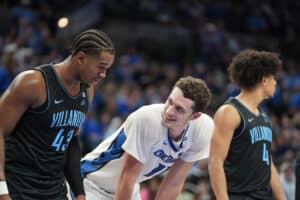 Creighton's Ryan Kalkbrenner (11) speaks with Villanova's Eric Dixon (43). The two combined for 50 points in the Creighton win. Photo by Brandon Tiedemann.