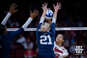 Nebraska Cornhuskers outside hitter Taylor Landfair (12) tips the ball against Penn State Nittany Lions setter Izzy Starck (21) during the semi-final round in the NCAA championship Thursday, December 19, 2024, in Louisville, Kentucky. Photo by John S. Peterson.